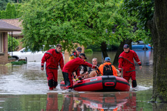 First responders rescue people from flooding in their homes on Aug. 10 after 13 inches of rain fell overnight in Wauwatosa, Wis. Credit: Andy Manis/Getty Images