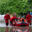 First responders rescue people from flooding in their homes on Aug. 10 after 13 inches of rain fell overnight in Wauwatosa, Wis. Credit: Andy Manis/Getty Images