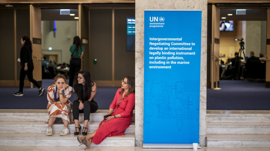Delegates rest outside of the assembly hall in Geneva, after talks aimed at striking a landmark treaty on plastic pollution ended with no consensus. Credit: Fabrice Coffrini/AFP via Getty Images
