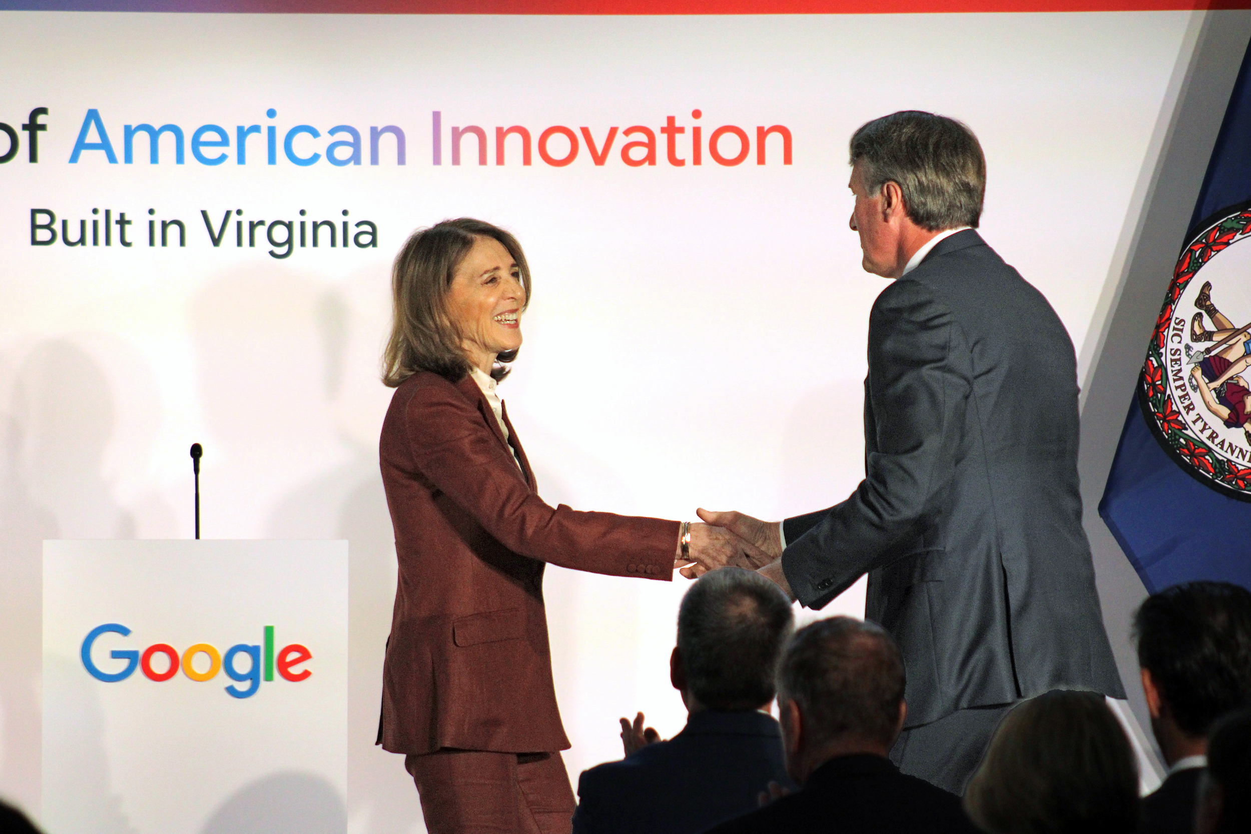 Ruth Porat, Google and Alphabet president and chief investment officer, and Gov. Glenn Youngkin shake hands at a company announcement on Wednesday. Credit: Charles Paullin/Inside Climate News
