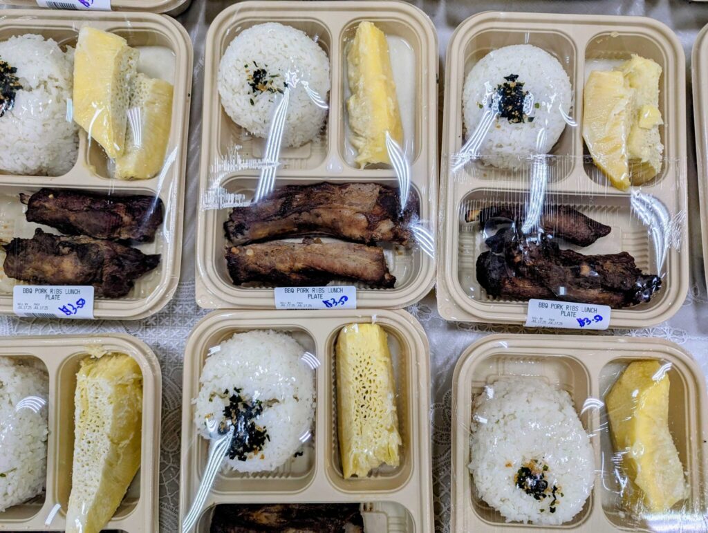 A typical Marshallese plate lunch at K&K Island Pride Super Market in Delap-Uliga-Djarrit, which includes rice alongside breadfruit and meat. Rice contributes at least one calorie in four for the average resident of the Marshall Islands, as a cheap belly-filling food. Credit: Thomas Heaton/Civil Beat