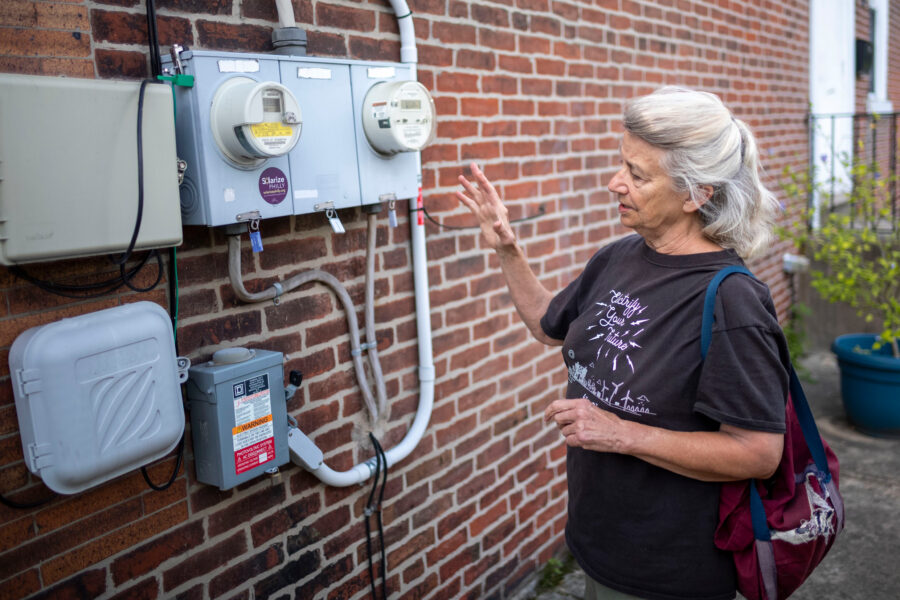 Liz Robinson, executive director at Philadelphia Solar Energy Association, at her solar-powered rental property in Philadelphia on Sept. 3. Credit: Laurence Kesterson/Inside Climate News