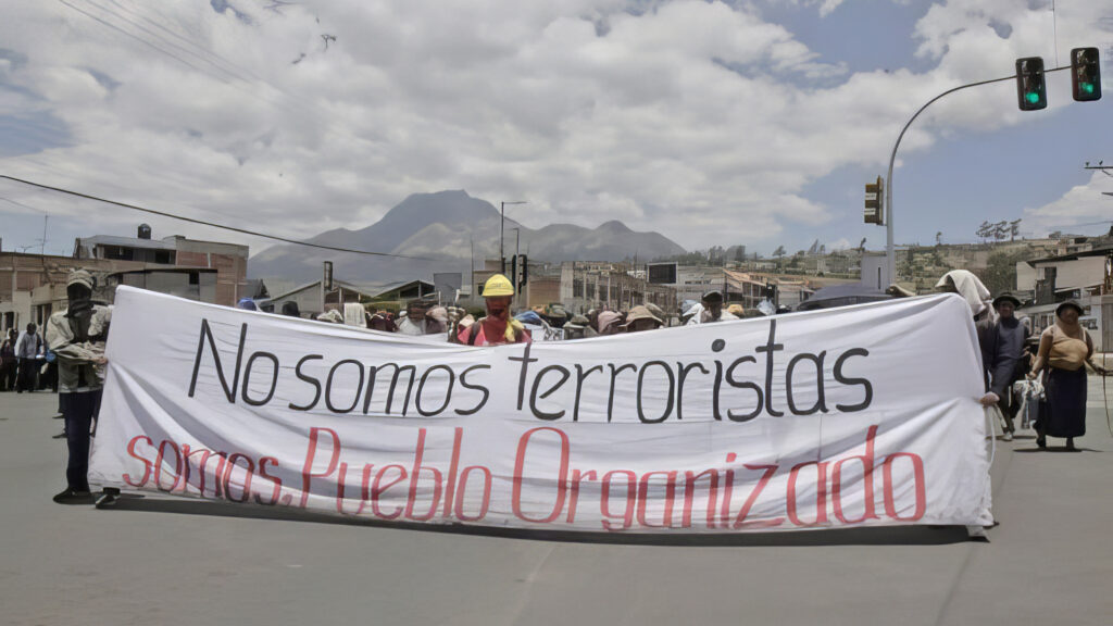 Protesters in Ecuador carry a sign saying “We are not terrorists, we are organized people,” on Saturday. Credit: Courtesy of CONAIE