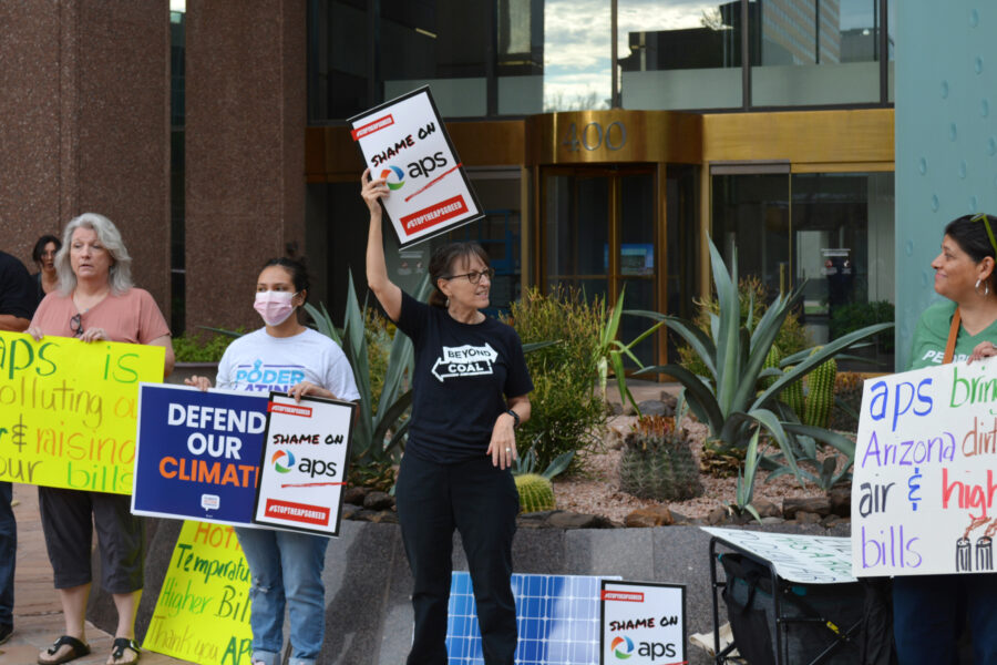Sandy Bahr (center), the Sierra Club’s Grand Canyon chapter director, speaks during a protest on Thursday over Arizona Power Service’s recent decision to walk back its clean energy goals. Credit: Wyatt Myskow/Inside Climate News