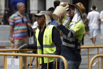A worker drinks water from a botijo, a Spanish traditional earthenware drinking jug, to fight the heat in the midst of a heat wave in Madrid on Aug. 9, 2023. Credit: Javier Soriano/AFP via Getty Images