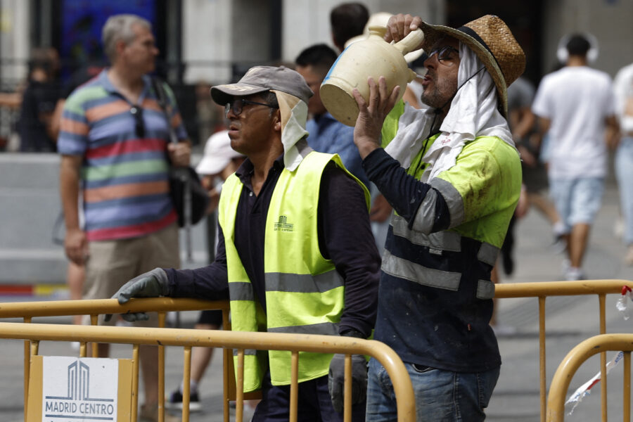 A worker drinks water from a botijo, a Spanish traditional earthenware drinking jug, to fight the heat in the midst of a heat wave in Madrid on Aug. 9, 2023. Credit: Javier Soriano/AFP via Getty Images