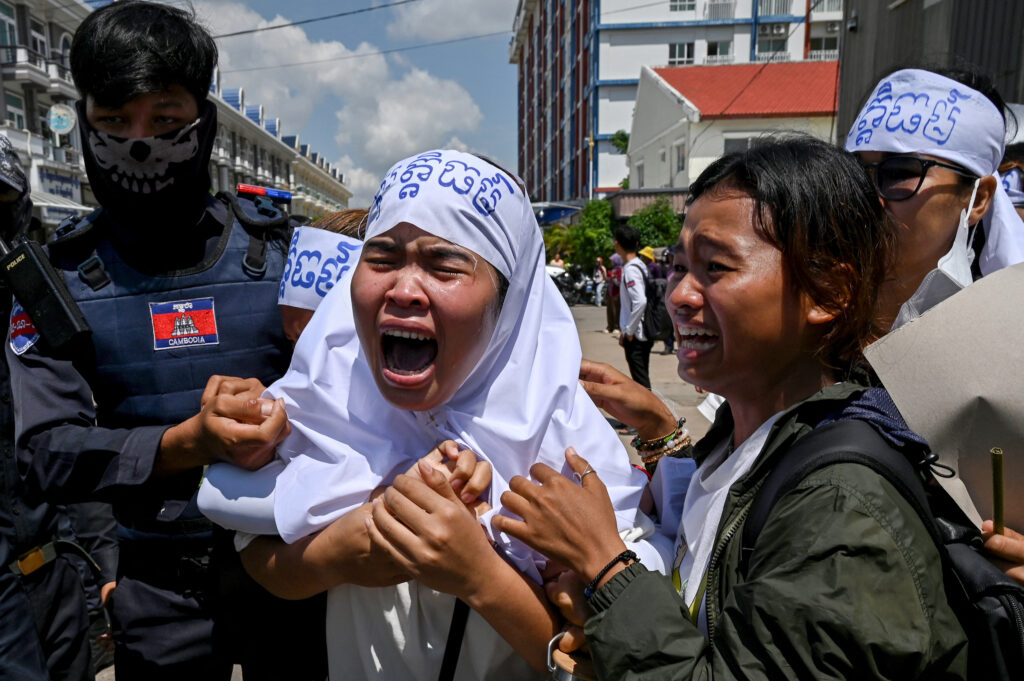 Cambodian environmental activists cry outside the Phnom Penh Municipal Court after 10 environmental defenders were sentenced in July 2024. Credit: Tang Chhin Sothy/AFP via Getty Images