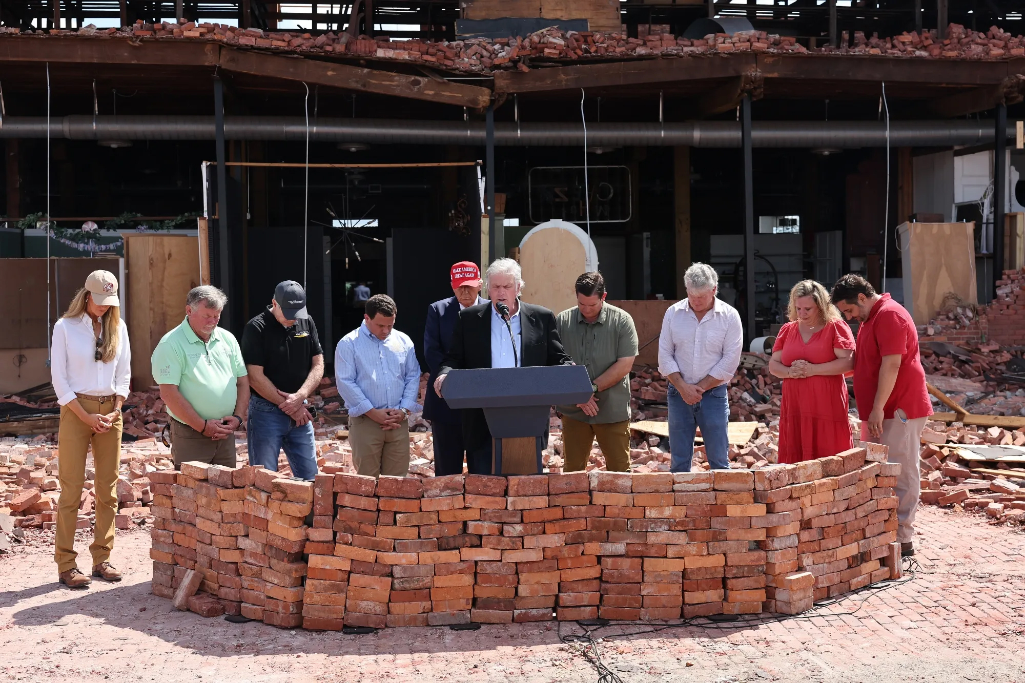 Franklin Graham, president of the nonprofit Samaritan’s Purse, says a prayer as he accompanies Donald Trump on a visit to see Hurricane Helene damage in Valdosta, Ga., on Sept. 30, 2024. Credit: Michael M. Santiago/Getty Images via Grist