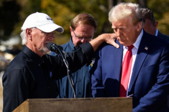 Donald Trump is prayed over by a local business owner in Swannanoa, N.C., during a visit to see the devastation of Hurricane Helene on Oct. 21, 2024. Credit: The Washington Post via Getty Images/Grist