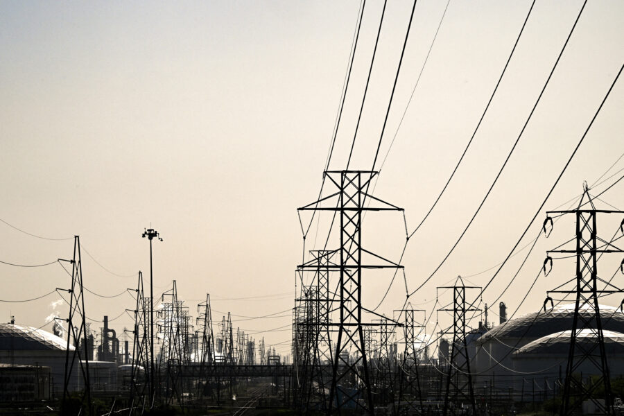 Transmission lines lead to an oil refinery in Deer Park, Texas. Credit: Ronaldo Schemidt/AFP via Getty Images