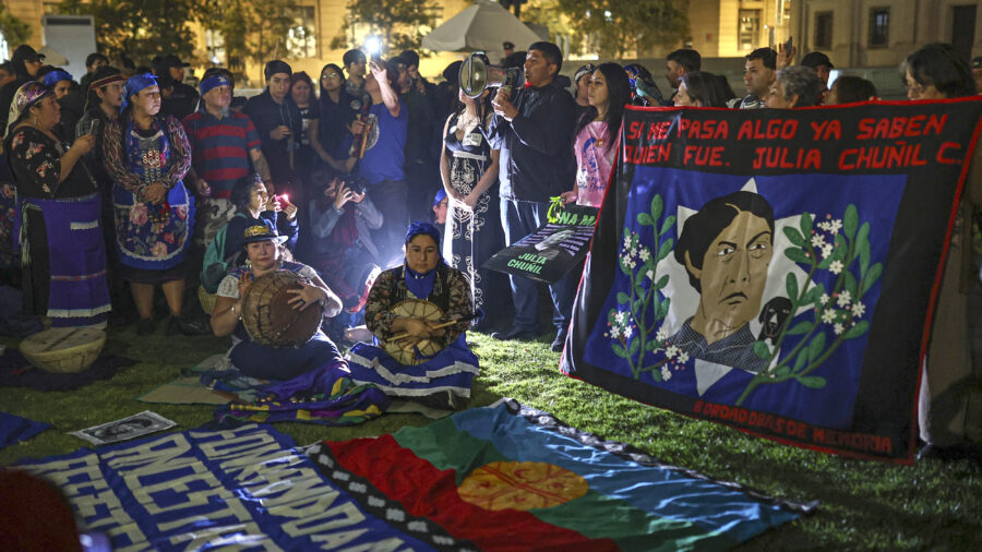 People gather for a protest against the disappearance of Mapuche leader and environmental defender Julia Chuñil in front of La Moneda Palace on April 8 in Santiago, Chile. Credit: Lucas Aguayo Araos/Anadolu via Getty Images