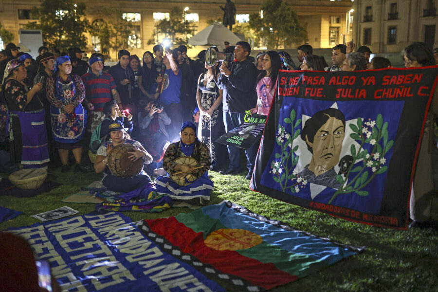 People gather for a protest against the disappearance of Mapuche leader and environmental defender Julia Chuñil in front of La Moneda Palace on April 8 in Santiago, Chile. Credit: Lucas Aguayo Araos/Anadolu via Getty Images