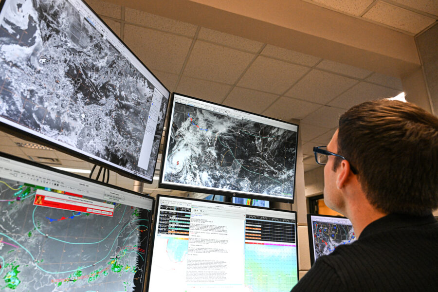 Tropical analysis meteorologist Aidan Mahoney works at his station at NOAA’s National Hurricane Center in Miami on May 30. Credit: Chandan Khanna/AFP via Getty Images