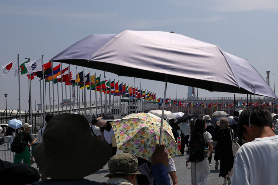 People shield themselves from the sun during a heat wave on Aug. 27 in Osaka, Japan. As deadly heat waves kill tens of thousands worldwide annually, the United Nations Environmental Programme has started controversial discussions about concepts to build an atmospheric umbrella for the Earth. Credit: Buddhika Weerasinghe/Getty Images