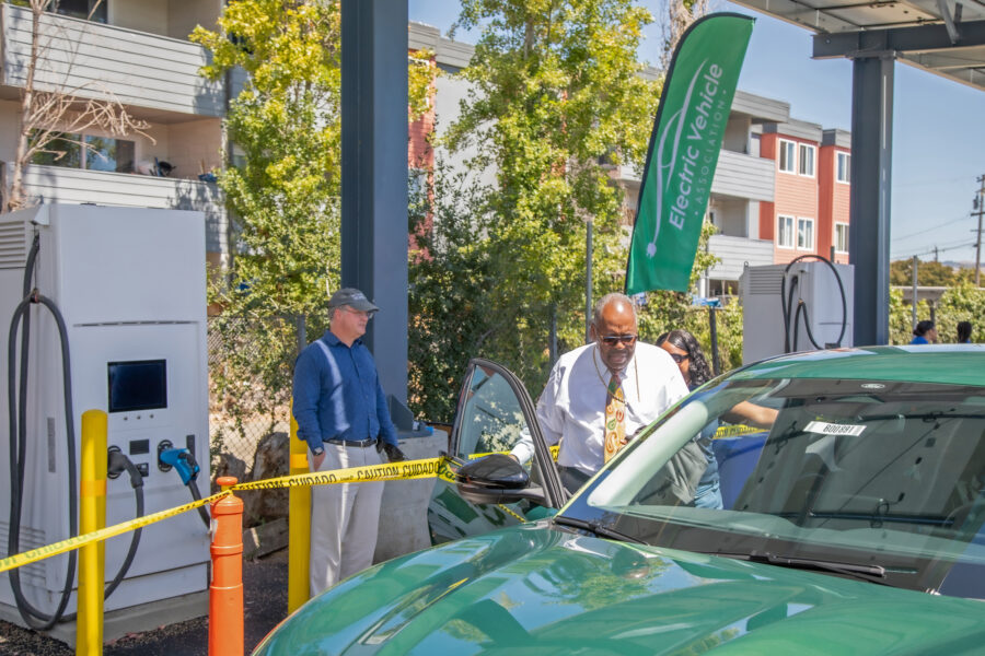 Glad Tidings’ founder, Bishop Jerry Macklin and one of the church’s new EV charging stations. Credit: Courtesy of Glad Tidings
