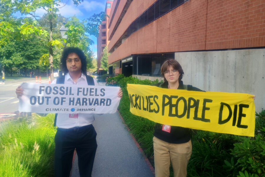 Eshaan Vakil (left), an organizer with Climate Defiance, and Barbara Sheehan, with Sunrise Movement, are two of the activists who disrupted a panel discussion with Occidental Petroleum CEO Vicki Hollub at a Harvard climate symposium on Friday. Credit: Phil McKenna/Inside Climate News