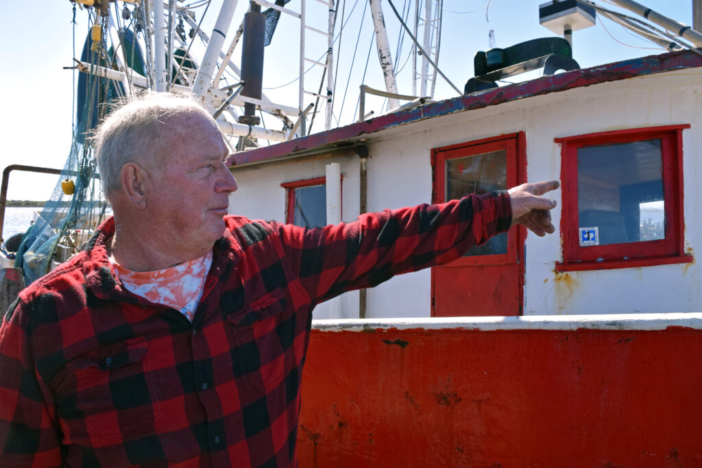 Commercial shrimper Phillip Dyson stands next to his boat, Papa’s Shadow, in Cameron, La. Credit: Phil McKenna/Inside Climate News