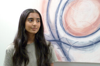 Mira Shah, who recently started a student-run climate economics journal, at her father’s office in Dublin, Calif. Credit: Liza Gross/Inside Climate News