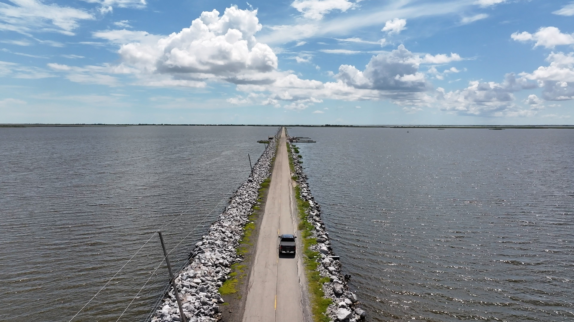 Isle de Jean Charles clings to the Louisiana coast by a narrow road flanked by rising gulf waters. Credit: Evan Simon/Floodlight