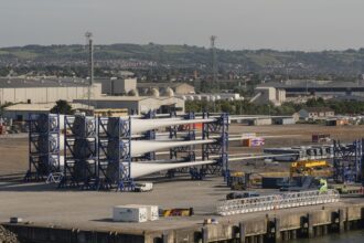 At Climate Week NYC, an official said the United Kingdom would expand offshore wind as part of its national climate action plan. Here, in Belfast, Norther Ireland, wind turbine blades are assembled in Belfast Harbor. Credit: Peter Titmuss/UCG/ Universal Images Group via Getty Images