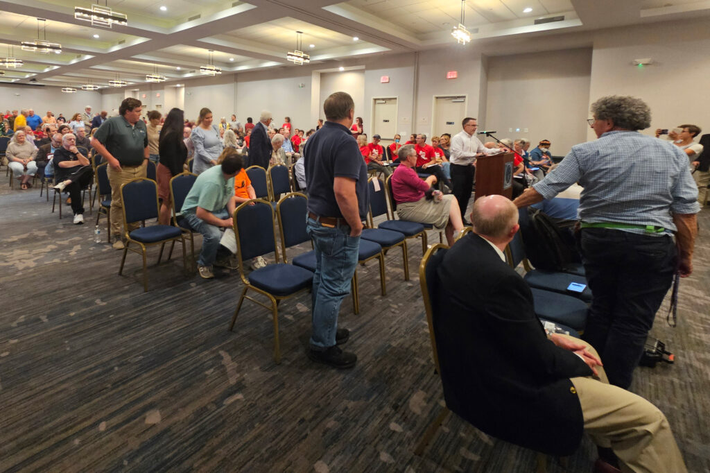 Supporters of the Virginia Energy Reliability Alliance stand up at the request of Brent Archer at the Virginia Department of Environmental Quality public hearing on Sept. 8. Credit: Charles Paullin/Inside Climate News