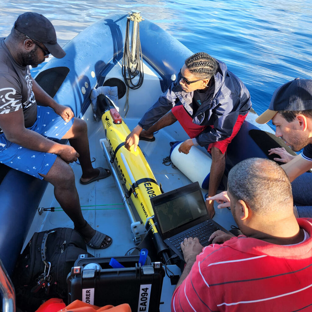 Project CETI's team works with a "glider," used by researchers to gather data by swimming alongside whales. Credit: Project CETI