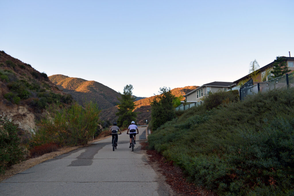 Two bikers set off on a trail outside of a housing development in Corona, California, which borders the Cleveland National Forest. Just a couple of miles away is the forest’s roadless area. Credit: Wyatt Myskow/Inside Climate News