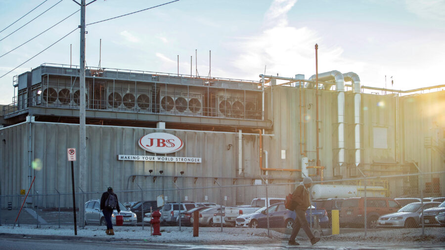 Employees walk past the JBS plant in Marshalltown, Iowa. A new report lists the Brazilian meat giant as a top five greenhouse gas emitter. Credit: KC McGinnis/The Washington Post via Getty Images