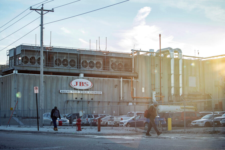 Employees walk past the JBS plant in Marshalltown, Iowa. A new report lists the Brazilian meat giant as a top five greenhouse gas emitter. Credit: KC McGinnis/The Washington Post via Getty Images