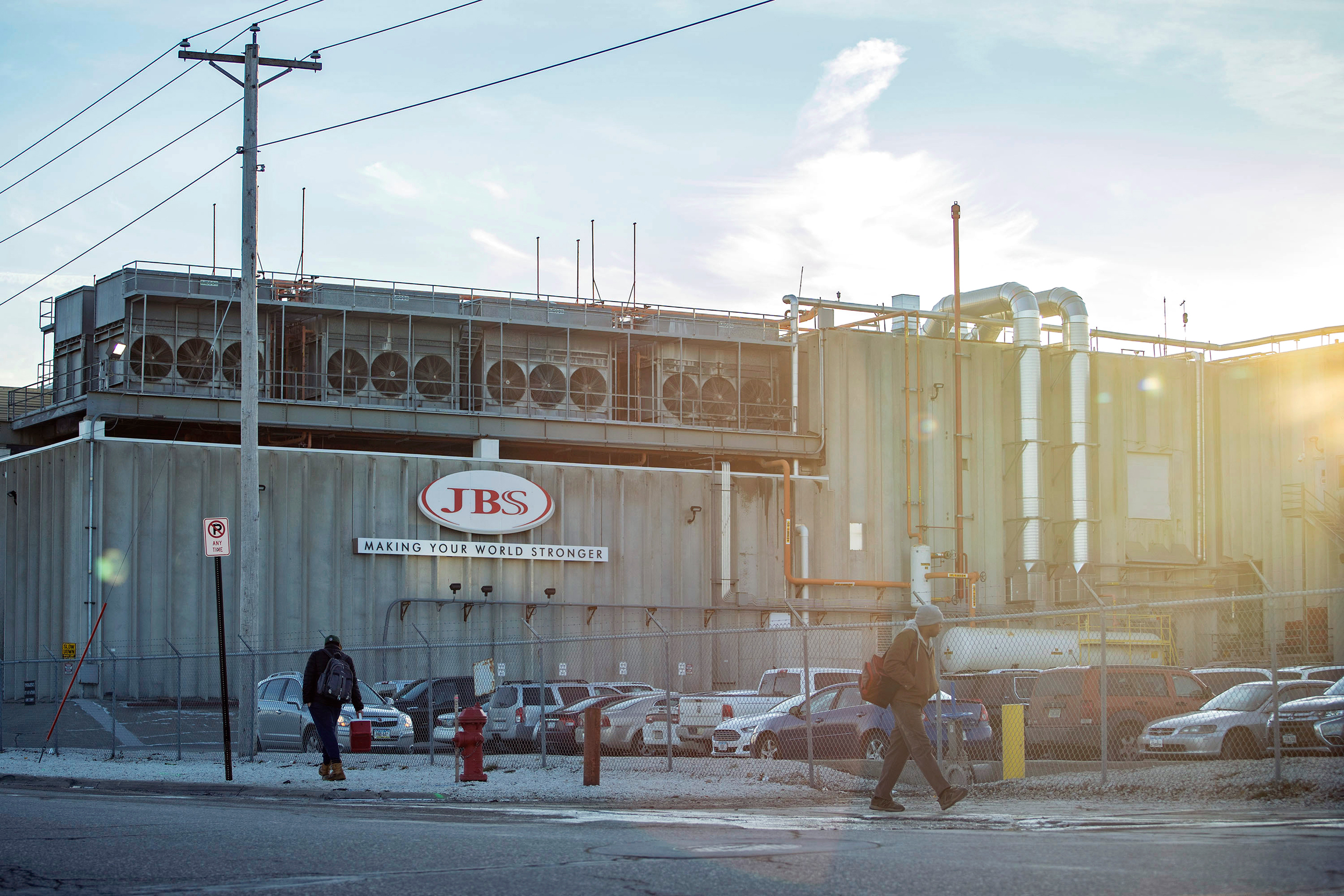 Employees walk past the JBS plant in Marshalltown, Iowa. A new report lists the Brazilian meat giant as a top five greenhouse gas emitter. Credit: KC McGinnis/The Washington Post via Getty Images
