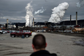 White plumes of smoke billow above U.S. Steel’s Clairton Coke Works in Clairton, Pa. Credit: Brendan Smialowski/AFP via Getty Images