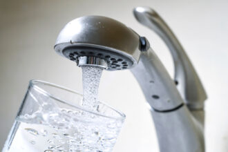 The settlement payout compensates customers for expenses in avoiding drinking water tainted with a “forever chemical” in October 2021. Credit: Ben Hasty/MediaNews Group/Reading Eagle via Getty Images