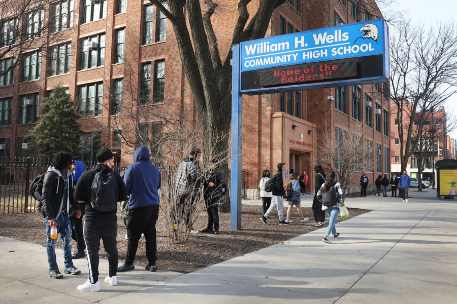 Students gather outside Wells Community Academy High School at the end of the school day on March 14, 2022, in Chicago. Credit: Scott Olson/Getty Images