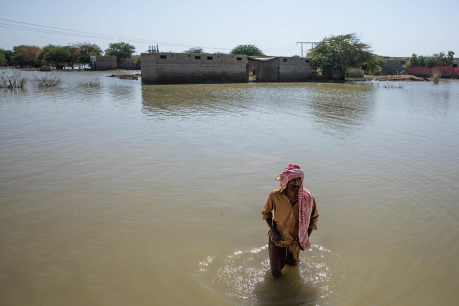A man wades through floodwater on Oct. 18, 2022, in Johi, Pakistan. Nearly one-third of Pakistan was deeply affected by flooding which hit the country in 2022. Credit: Getty Images