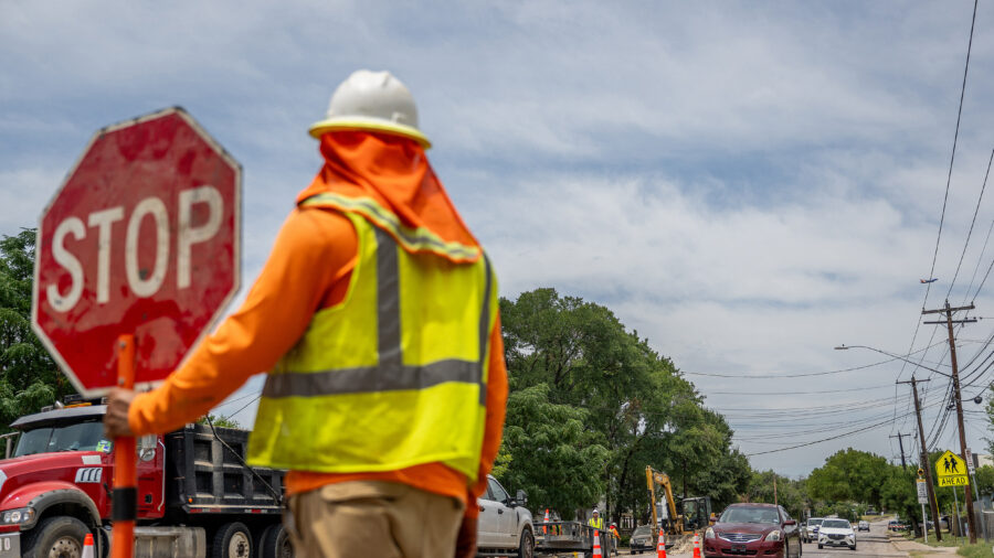 A construction worker ushers traffic on July 11, 2023, during a record-setting heat wave in Austin, Texas. Credit: Brandon Bell/Getty Images