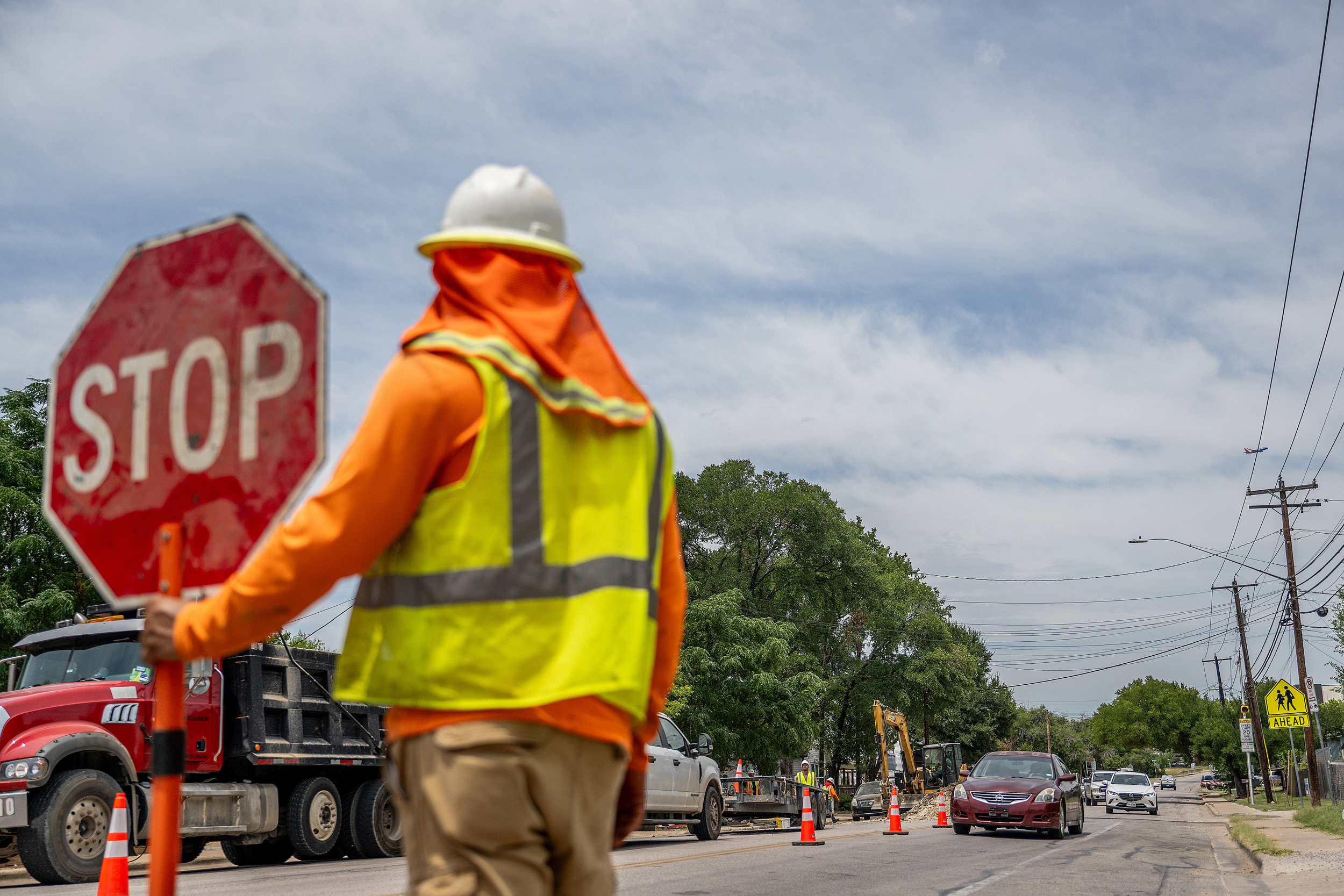 A construction worker ushers traffic on July 11, 2023, during a record-setting heat wave in Austin, Texas. Credit: Brandon Bell/Getty Images