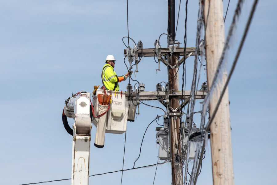 A Central Maine Power lineworker repairs a transmission line in Portland, Maine. Credit: Brianna Soukup/Portland Press Herald via Getty Images