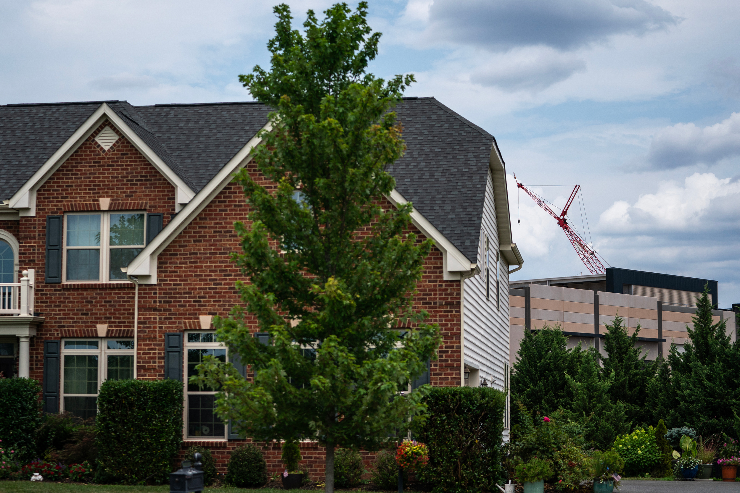An Amazon Web Services data center sits behind single-family homes in Stone Ridge, Va. Credit: Nathan Howard/Getty Images