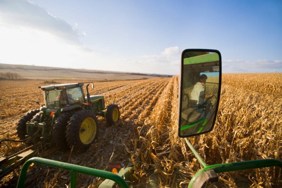 A combine harvests corn alongside a tractor near Northland, Minn. Credit: Richard Hamilton Smith/Universal Images Group via Getty Images