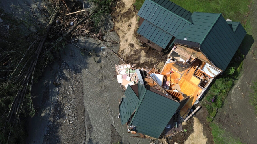 An aerial view of a partially collapsed home in St. Johnsbury, Vt., on July 30, 2024, after flash floods hit the area. Vermont, along with New York, passed climate superfund laws last year, and similar legislation is pending in a handful of other states. Credit: Danielle Parhizkaran/The Boston Globe via Getty Images