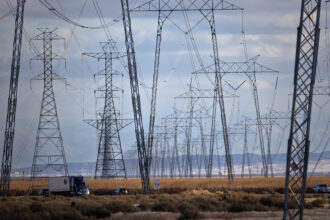 High-voltage transmission lines run along Interstate 5 in the central California community of Buttonwillow. Credit: Jay L. Clendenin/Getty Images