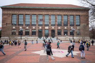 Students walk through the University of Michigan campus on April 3 in Ann Arbor, Mich. Credit: Bill Pugliano/Getty Images