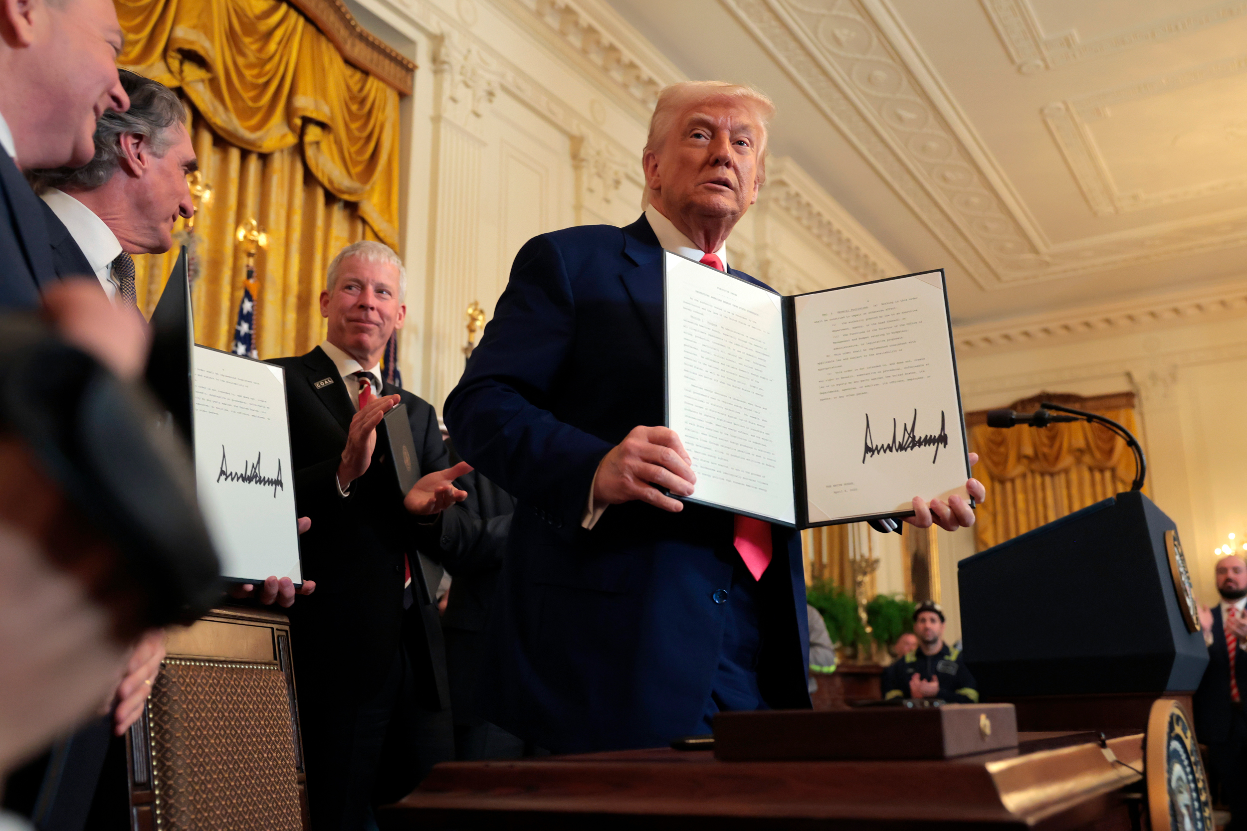 President Donald Trump poses for photos after signing a series of executive orders on American energy production during a ceremony in the East Room of the White House on April 8. Trump was joined by (from left) EPA Administrator Lee Zeldin, Interior Secretary Doug Bergum and Energy Secretary Chris Wright. Credit: Anna Moneymaker/Getty Images