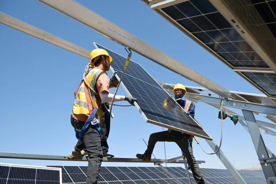 Workers install solar panels at the Ningguoyun Lingwu 1 million kilowatt photovoltaic project in the desert of China’s northern Ningxia region on April 14. Credit: STR/AFP via Getty Images