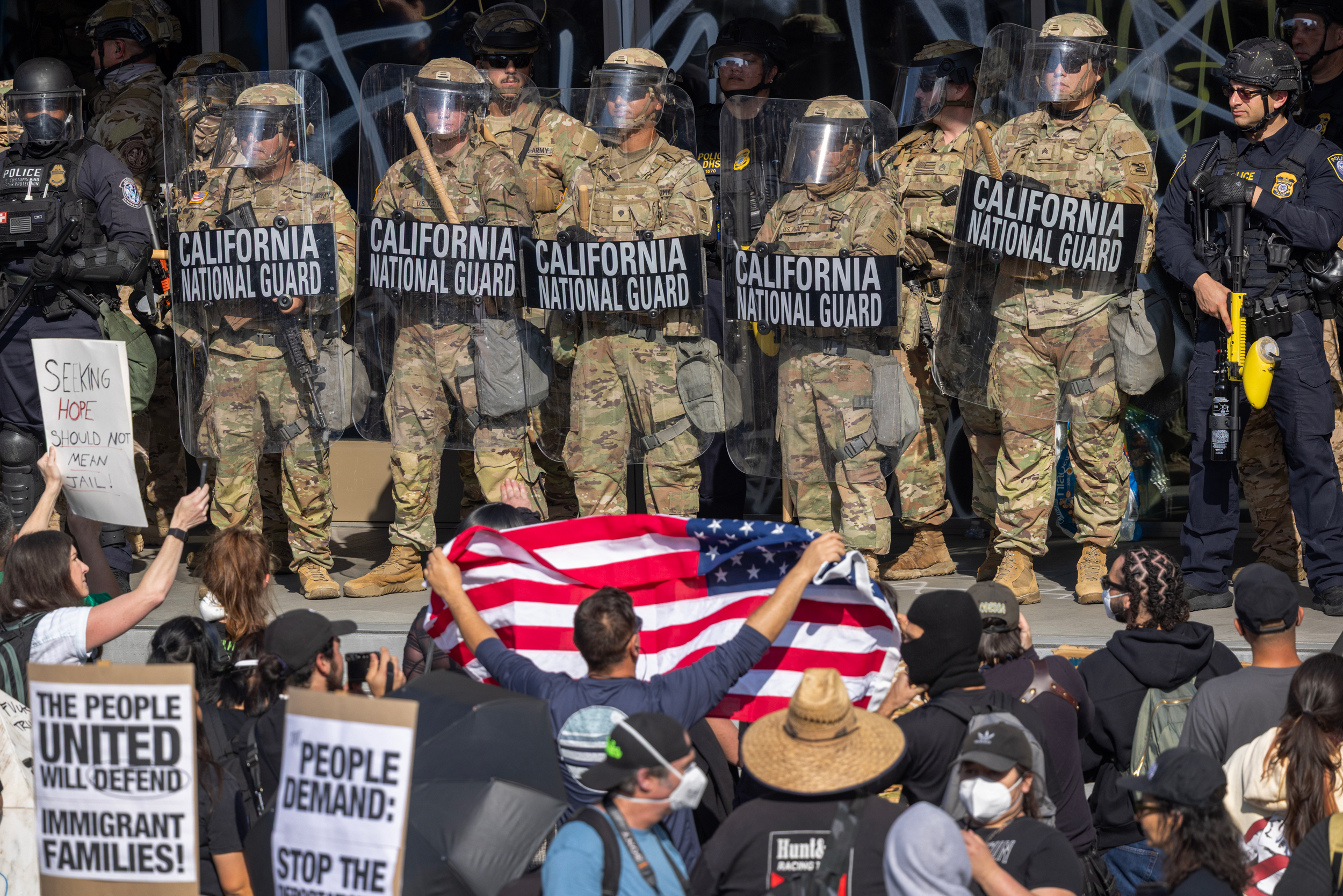 Protesters confront California National Guard soldiers and police outside a federal building in Los Angeles on June 9. Credit: David McNew/Getty Images
