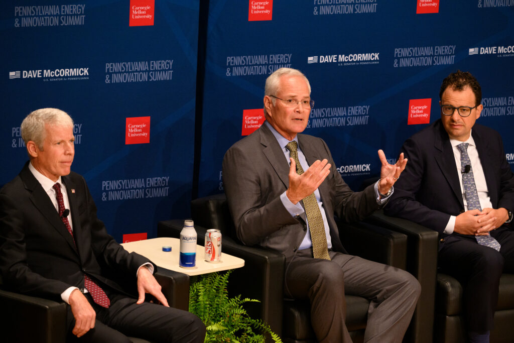 Darren Woods, CEO of ExxonMobil, speaks alongside Energy Secretary Chris Wright (left) and Dario Amodei, CEO of Anthropic, at the Pennsylvania Energy and Innovation Summit at Carnegie Mellon University on July 15 in Pittsburgh. Credit: Jeff Swensen/Getty Images