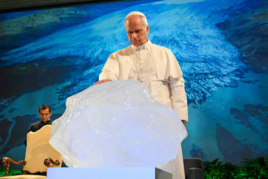 Pope Leo XIV delivers a speech with a chunk of glacial ice during a climate conference on Wednesday in Albano Laziale, Italy. Credit: Simone Risoluti/Vatican Media via Getty Images