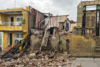 People salvage belongings from the rubble of their home on Wednesday after it collapsed during Hurricane Melissa’s passage through Santiago de Cuba. Credit: Yamil Lage/AFP via Getty Images