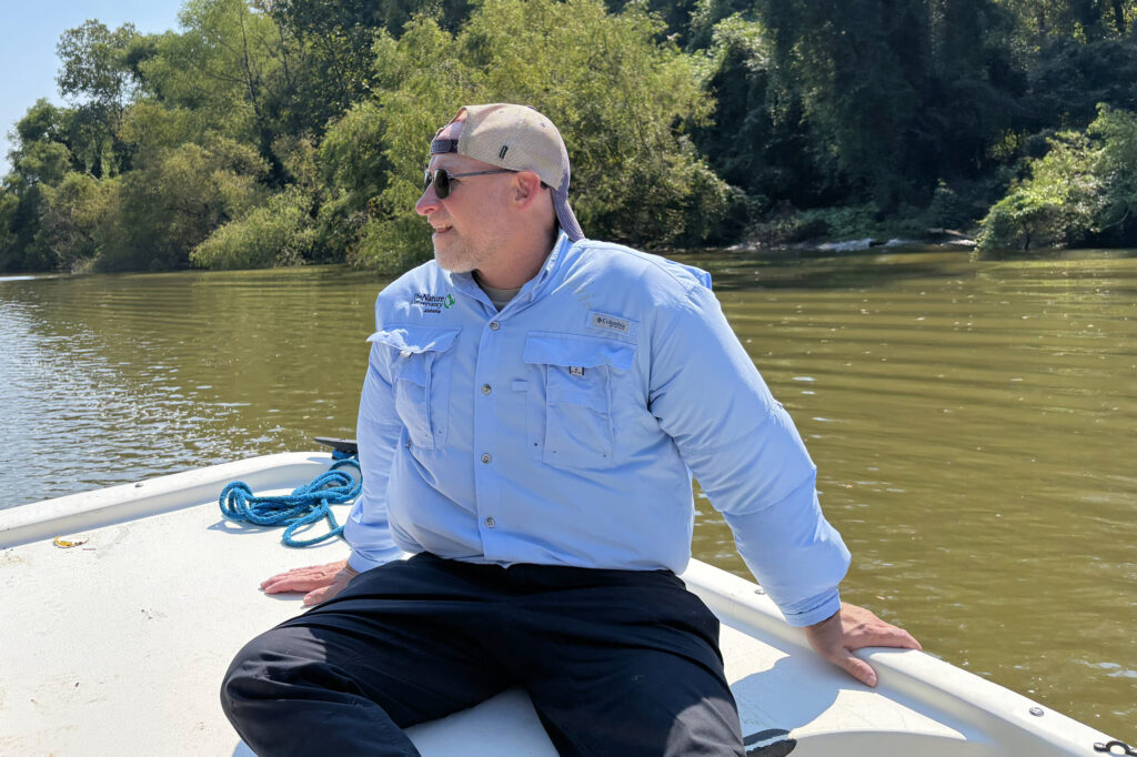 Mitch Reid, state director for The Nature Conservancy in Alabama, rides toward the new preserve in Clarke County, Ala. Credit: Dennis Pillion/Inside Climate News