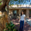 Baysi Vasquez’s daughter, Ivanna, stands in front of their home where heat pumps were installed. “All farmworkers deserve the right to affordable air conditioning,” she said. Credit: Twilight Greenaway/Inside Climate News